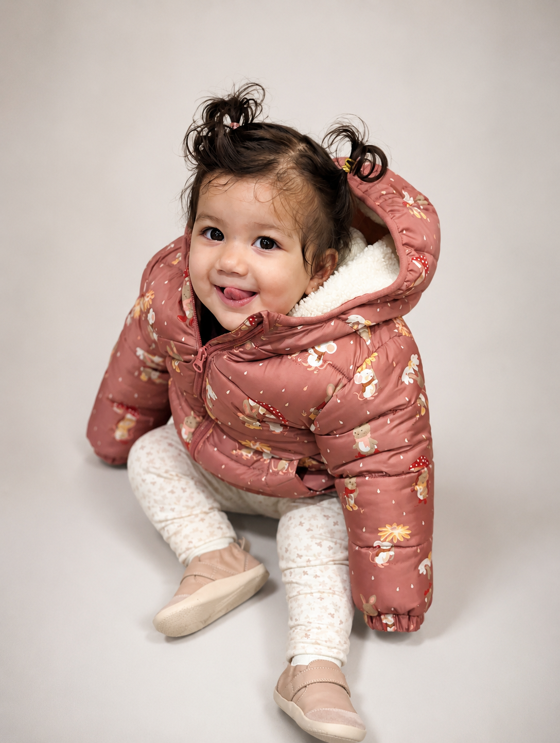Saanvi in a pink puffer jacket, laughing